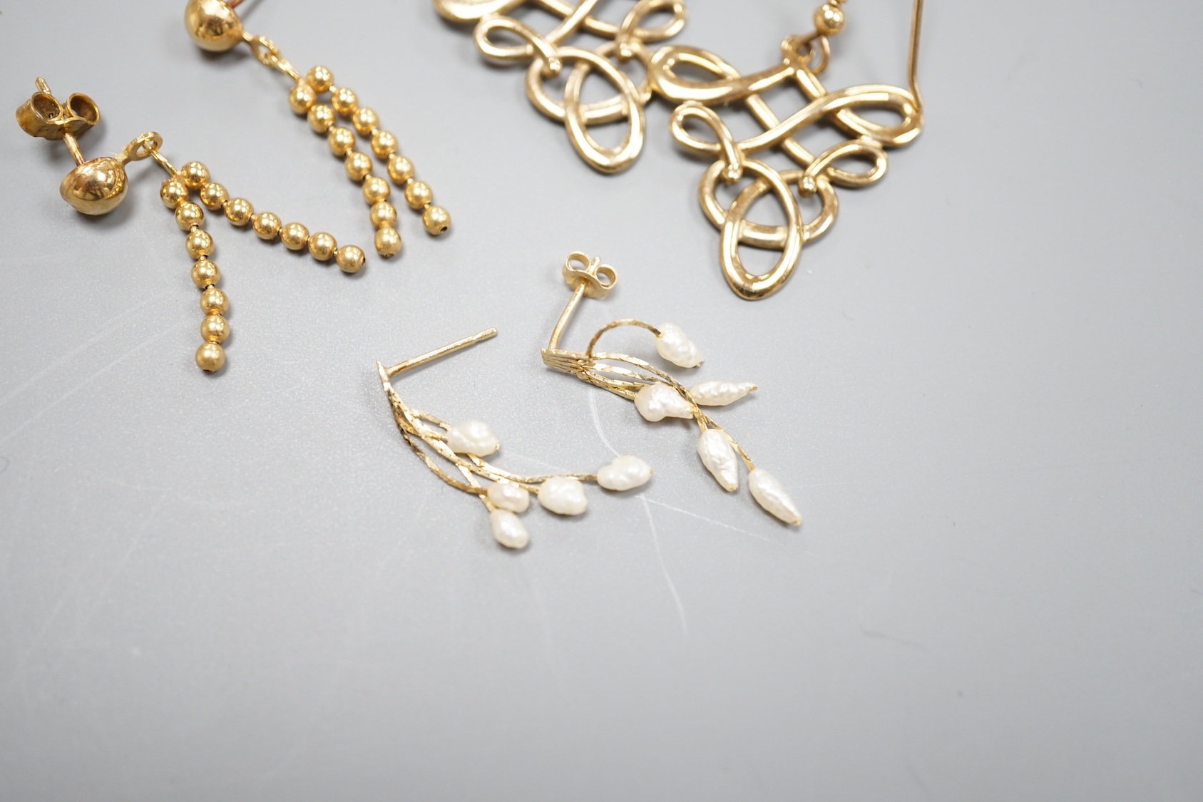 Two pairs of modern 9ct gold earrings including interwoven and tassel drop, 6.5 grams and a pair of 14k and baroque pearl drop earrings, gross 0.9 grams.